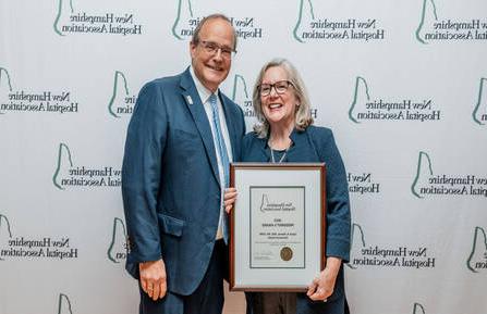 Susan Reeves stands with Steve Ahnen holding award